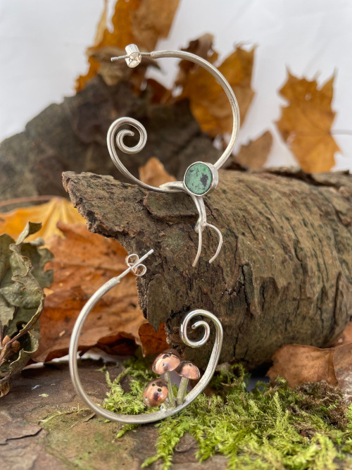unfurling-fern-earrings.jpeg**Unfurling fern earrings**Large hoop sterling silver earrings depicting the unfurling of a young fern and decorated with my statement toadstools and snail. Finished with mille-fleur or gemstones. **1**1 	**170**,21,26,27,28,**,1,2,5,6,**